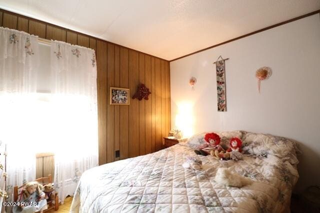 bedroom featuring wooden walls