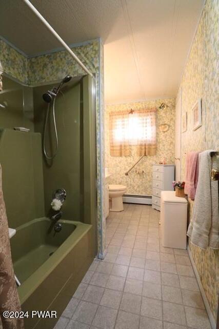 bathroom with baseboard heating, toilet, and shower / washtub combination