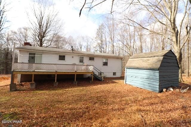 rear view of house featuring a deck