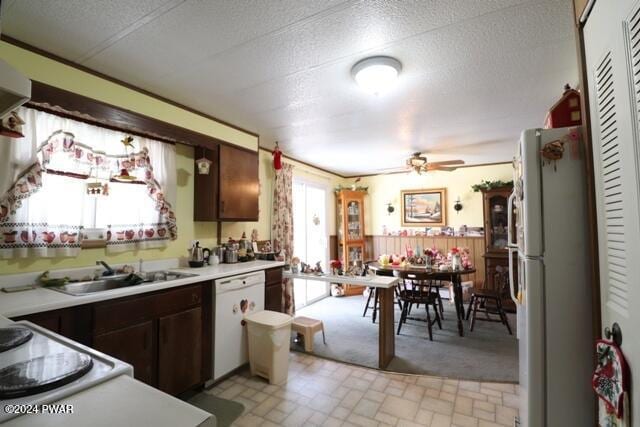 kitchen with dishwasher, refrigerator, dark brown cabinets, and sink