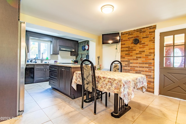 kitchen with decorative backsplash, dark brown cabinets, sink, dishwasher, and range hood