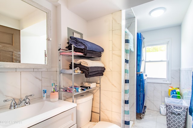 bathroom featuring vanity, toilet, tile walls, and curtained shower