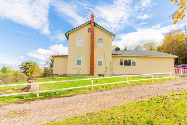 back of property with a lawn