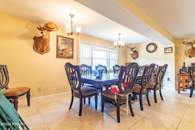 tiled dining room with a notable chandelier