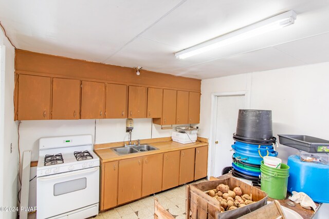 kitchen featuring gas range gas stove and sink