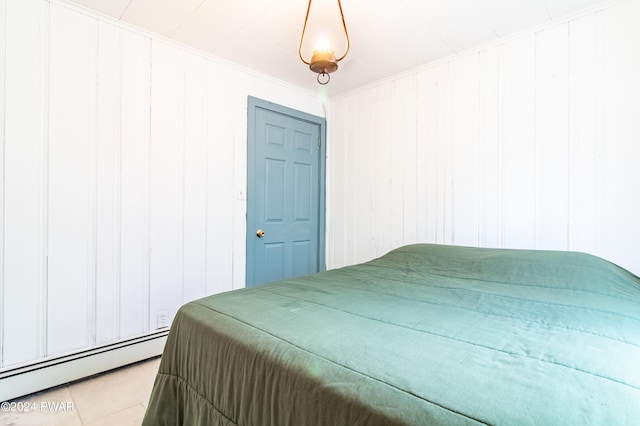 bedroom with light tile patterned floors and a baseboard radiator