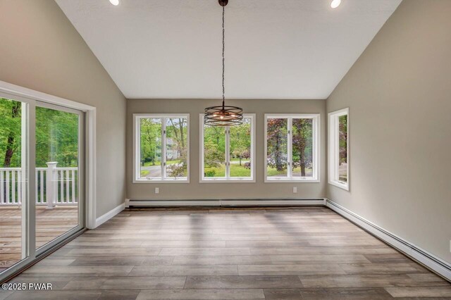 103 Goldrush Dr, Lords Valley, PA 18428 - unfurnished dining area featuring vaulted ceiling, a baseboard radiator, a baseboard heating unit, wood finished floors, and recessed lighting