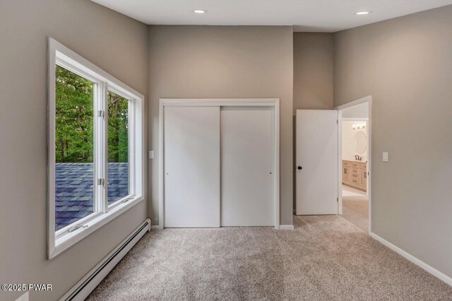 103 Goldrush Dr, Lords Valley, PA 18428 - unfurnished bedroom with baseboard heating, carpet, a closet, and recessed lighting