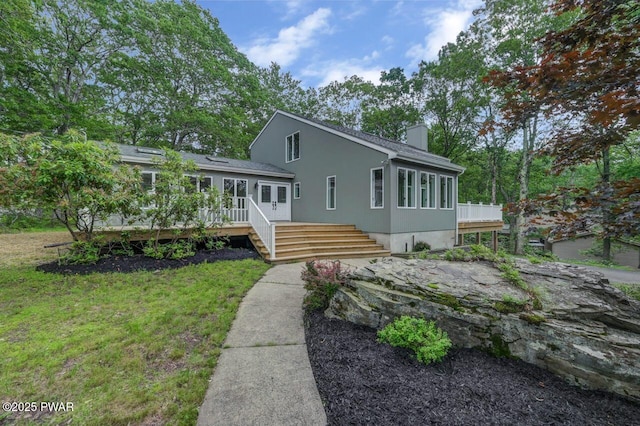 103 Goldrush Dr, Lords Valley, PA 18428 - view of front of property featuring a wooden deck, a chimney, a front lawn, and stairs