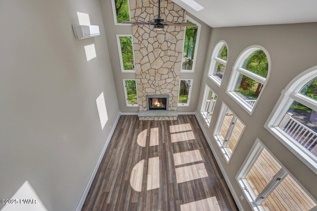103 Goldrush Dr, Lords Valley, PA 18428 - unfurnished living room with high vaulted ceiling, plenty of natural light, wood finished floors, and a fireplace