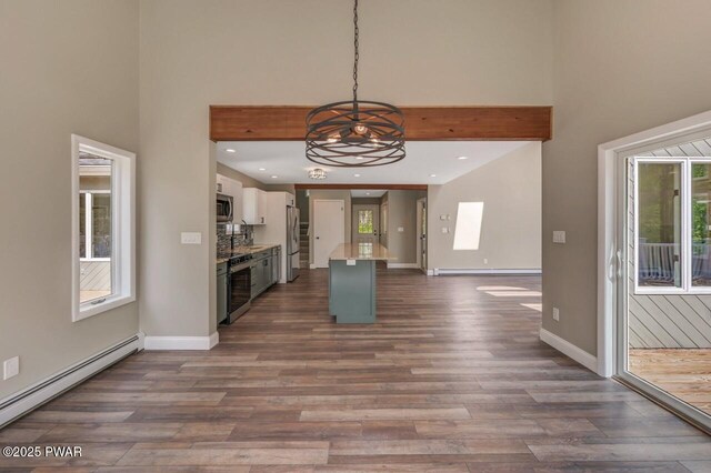 103 Goldrush Dr, Lords Valley, PA 18428 - kitchen featuring a baseboard radiator, a towering ceiling, refrigerator with ice dispenser, plenty of natural light, and a chandelier