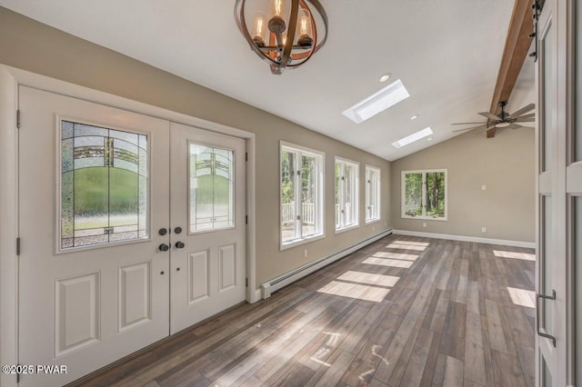 103 Goldrush Dr, Lords Valley, PA 18428 - foyer featuring baseboard heating, a skylight, vaulted ceiling, wood finished floors, and a chandelier