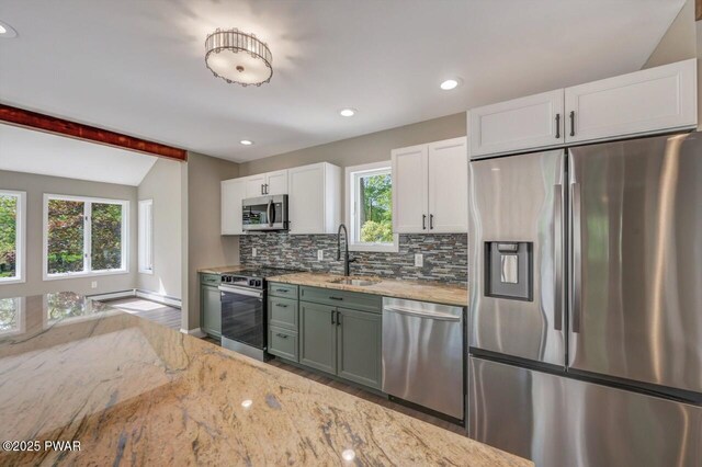 103 Goldrush Dr, Lords Valley, PA 18428 - kitchen with appliances with stainless steel finishes, tasteful backsplash, white cabinets, light stone counters, and recessed lighting