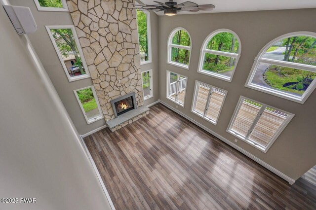 103 Goldrush Dr, Lords Valley, PA 18428 - unfurnished living room featuring a wall mounted air conditioner, plenty of natural light, wood finished floors, and a high ceiling