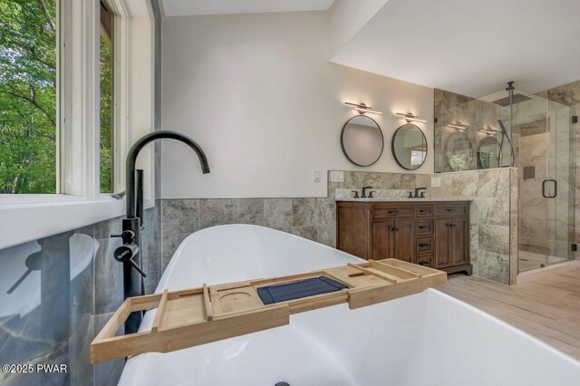 103 Goldrush Dr, Lords Valley, PA 18428 - bathroom featuring tile walls, a shower stall, healthy amount of natural light, a soaking tub, and double vanity