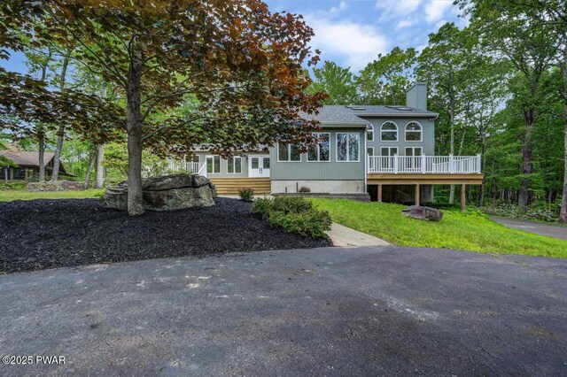 103 Goldrush Dr, Lords Valley, PA 18428 - back of house featuring a chimney and a wooden deck