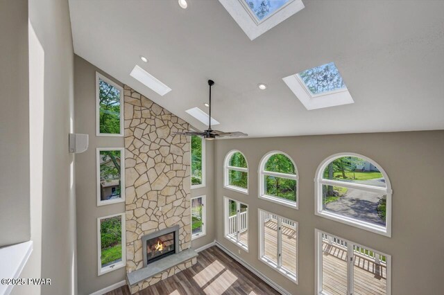 103 Goldrush Dr, Lords Valley, PA 18428 - unfurnished living room featuring a skylight, high vaulted ceiling, wood finished floors, recessed lighting, and a stone fireplace