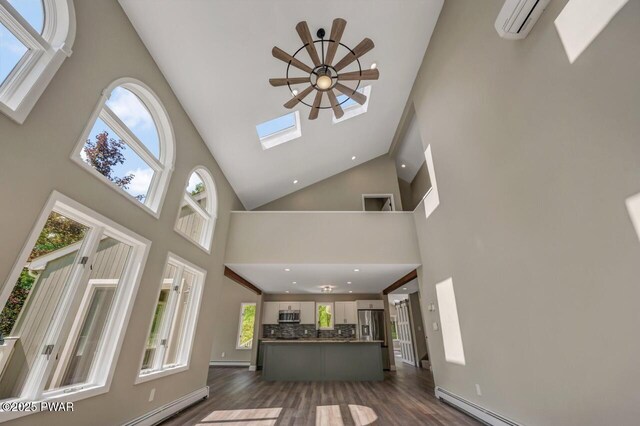 103 Goldrush Dr, Lords Valley, PA 18428 - living room featuring high vaulted ceiling, dark wood-style floors, recessed lighting, a skylight, and a baseboard heating unit