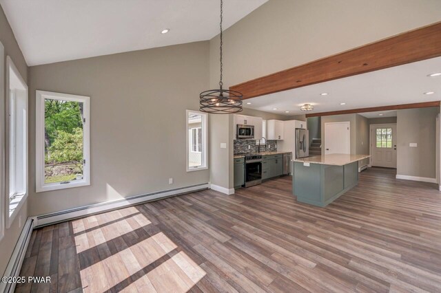 103 Goldrush Dr, Lords Valley, PA 18428 - kitchen with appliances with stainless steel finishes, white cabinetry, a chandelier, a baseboard heating unit, and vaulted ceiling