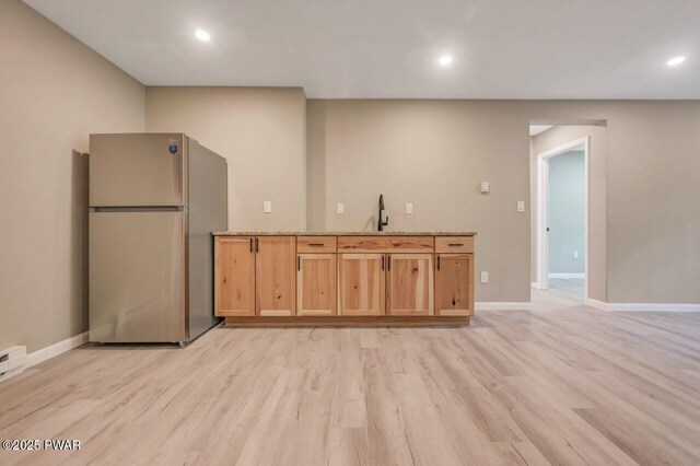 103 Goldrush Dr, Lords Valley, PA 18428 - kitchen with freestanding refrigerator, light wood-type flooring, recessed lighting, light stone countertops, and light brown cabinets