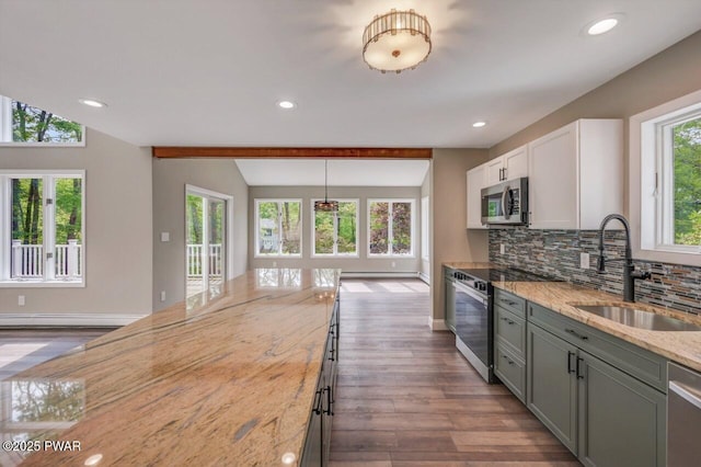 103 Goldrush Dr, Lords Valley, PA 18428 - kitchen featuring appliances with stainless steel finishes, light stone countertops, dark wood-style flooring, tasteful backsplash, and vaulted ceiling