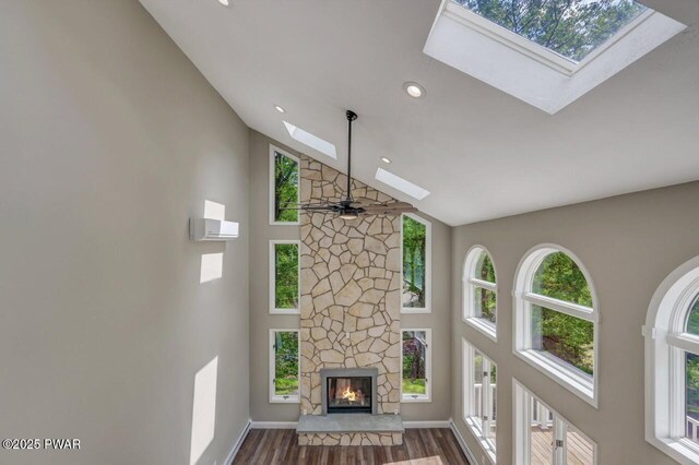 103 Goldrush Dr, Lords Valley, PA 18428 - unfurnished living room featuring a skylight, high vaulted ceiling, dark wood-style floors, recessed lighting, and healthy amount of natural light