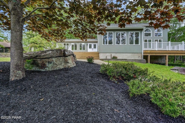103 Goldrush Dr, Lords Valley, PA 18428 - back of property with a wooden deck and entry steps
