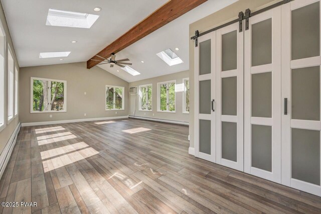 103 Goldrush Dr, Lords Valley, PA 18428 - unfurnished room with a skylight, a baseboard radiator, wood finished floors, recessed lighting, and a wall unit AC