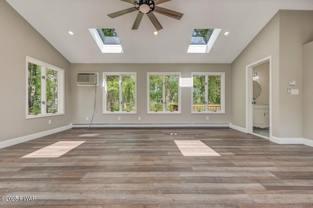 103 Goldrush Dr, Lords Valley, PA 18428 - unfurnished living room with a skylight, vaulted ceiling, a wall mounted air conditioner, wood finished floors, and recessed lighting