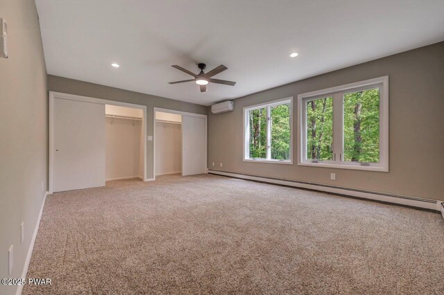 103 Goldrush Dr, Lords Valley, PA 18428 - unfurnished bedroom with a baseboard heating unit, two closets, a wall mounted air conditioner, light carpet, and recessed lighting