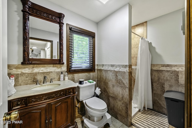 108 Bayberry Ct, East Stroudsburg, PA 18301 - full bath with tile walls, toilet, a stall shower, vanity, and a wainscoted wall