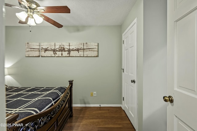 108 Bayberry Ct, East Stroudsburg, PA 18301 - bedroom with dark wood-style flooring, a textured ceiling, a ceiling fan, and baseboards