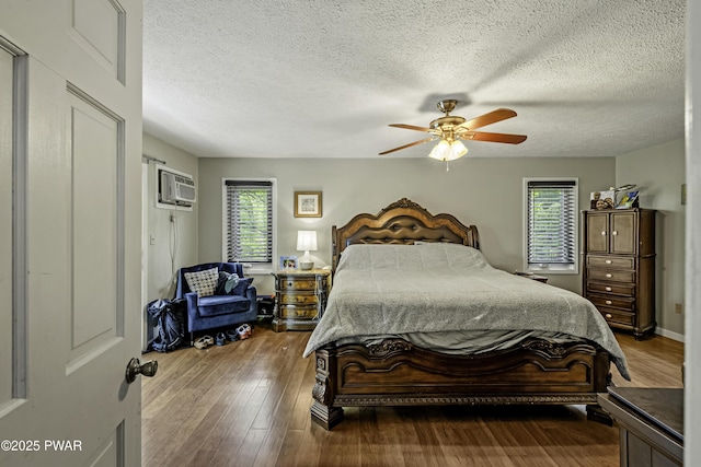 108 Bayberry Ct, East Stroudsburg, PA 18301 - bedroom with multiple windows, a wall mounted AC, wood finished floors, a textured ceiling, and a ceiling fan