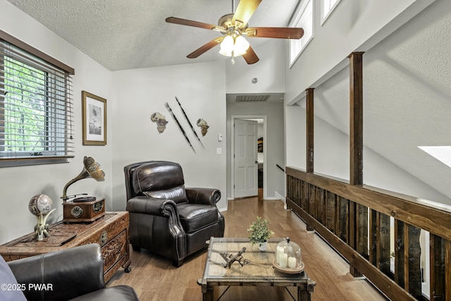 108 Bayberry Ct, East Stroudsburg, PA 18301 - living room featuring ceiling fan, wood finished floors, a textured ceiling, high vaulted ceiling, and a skylight