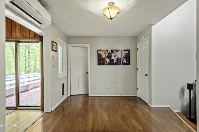 108 Bayberry Ct, East Stroudsburg, PA 18301 - entrance foyer with an AC wall unit, wood finished floors, baseboards, and a textured ceiling