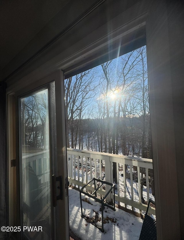 view of snow covered back of property