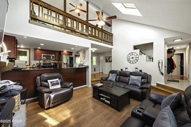 108 Bayberry Ct, East Stroudsburg, PA 18301 - living area featuring a skylight, wood finished floors, ceiling fan, plenty of natural light, and high vaulted ceiling