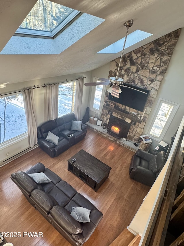 108 Bayberry Ct, East Stroudsburg, PA 18301 - living area featuring a skylight, wood finished floors, a fireplace, lofted ceiling, and ceiling fan