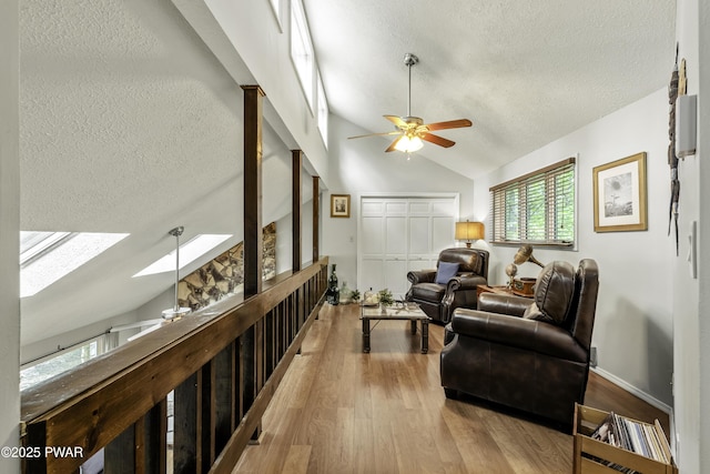 108 Bayberry Ct, East Stroudsburg, PA 18301 - living area featuring lofted ceiling, a textured ceiling, ceiling fan, a skylight, and wood finished floors