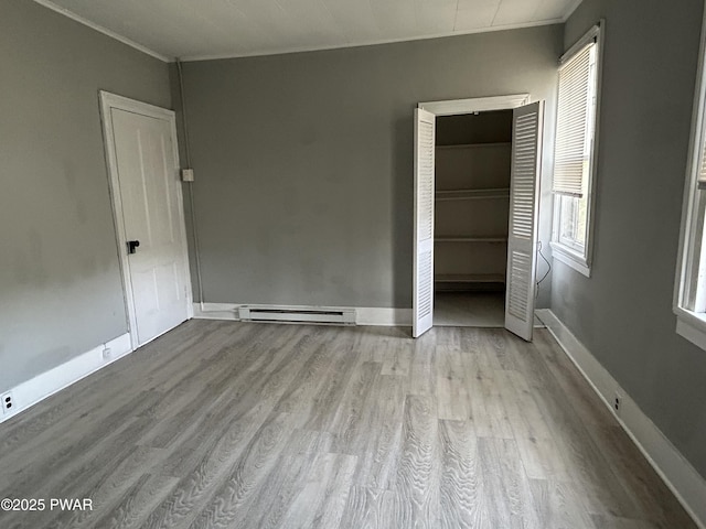 887 Maple Ave, Honesdale, PA 18431 - unfurnished bedroom with a baseboard radiator, crown molding, baseboards, and wood finished floors