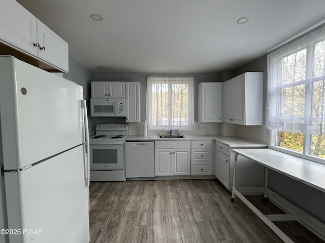 887 Maple Ave, Honesdale, PA 18431 - kitchen featuring light wood finished floors, a sink, white appliances, backsplash, and light countertops