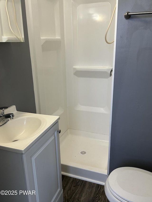 887 Maple Ave, Honesdale, PA 18431 - bathroom with vanity, wood finished floors, a shower stall, and toilet