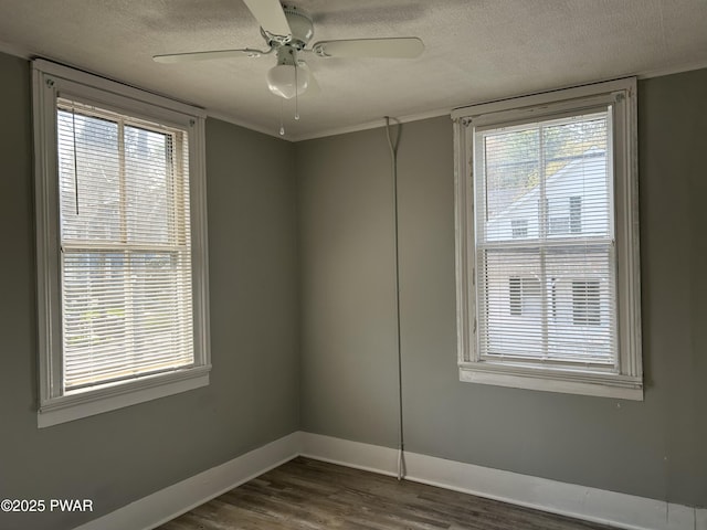 887 Maple Ave, Honesdale, PA 18431 - spare room featuring a ceiling fan, a textured ceiling, baseboards, ornamental molding, and dark wood finished floors