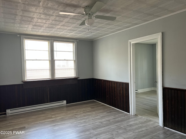887 Maple Ave, Honesdale, PA 18431 - empty room with an ornate ceiling, baseboard heating, and a wainscoted wall