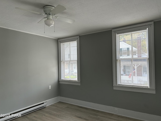 887 Maple Ave, Honesdale, PA 18431 - empty room featuring plenty of natural light, wood finished floors, a baseboard radiator, and a textured ceiling