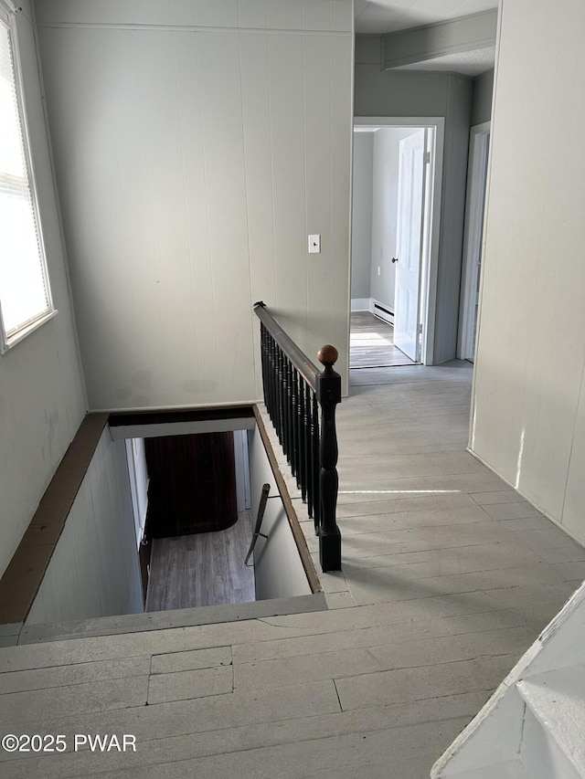 887 Maple Ave, Honesdale, PA 18431 - stairs featuring wood finished floors and a baseboard heating unit