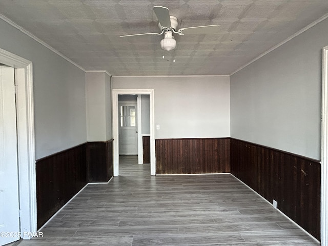 887 Maple Ave, Honesdale, PA 18431 - unfurnished room with wainscoting, ceiling fan, wooden walls, crown molding, and wood finished floors
