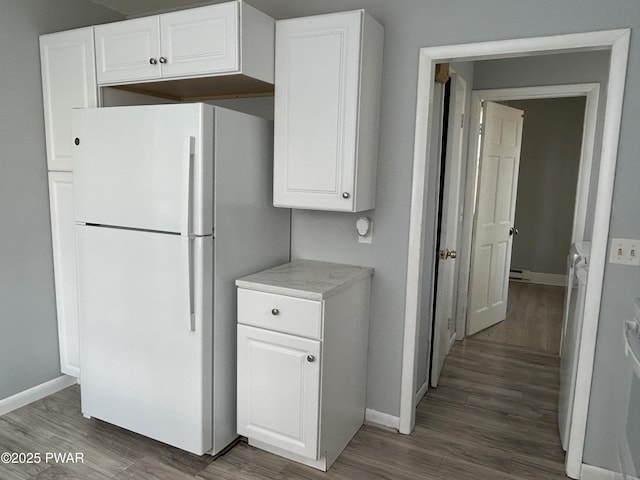887 Maple Ave, Honesdale, PA 18431 - kitchen with baseboards, light countertops, freestanding refrigerator, and wood finished floors