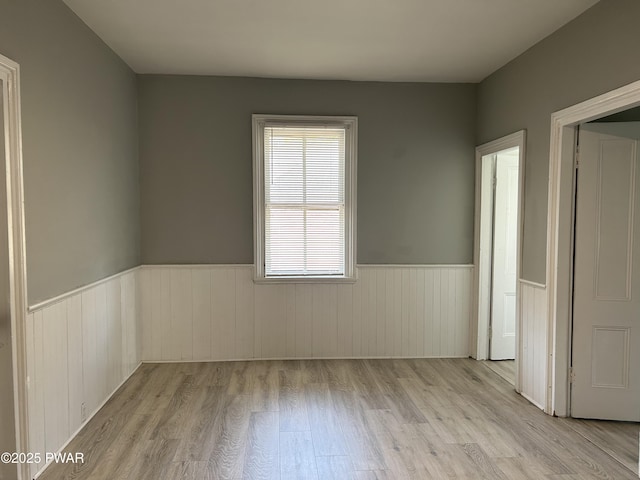 887 Maple Ave, Honesdale, PA 18431 - unfurnished bedroom with a wainscoted wall and wood finished floors