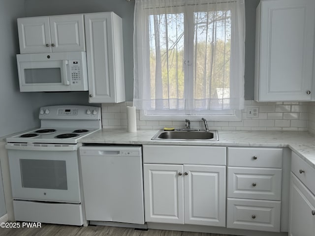 887 Maple Ave, Honesdale, PA 18431 - kitchen featuring a sink, white cabinetry, white appliances, decorative backsplash, and light stone counters